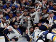 St. Louis Blues players pose for a team photo with the Stanley Cup after defeating the Boston Bruins in game seven of the 2019 Stanley Cup Final at TD Garden.