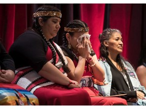Lorelei Williams, centre, whose cousin Tanya Holyk was murdered by serial killer Robert Pickton, wipes away tears after responding to the report of the National Inquiry into Missing and Murdered Indigenous Women and Girls in Vancouver, on June 3.