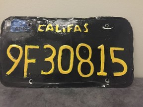 This undated photo provided by the Ventura County Sheriff's Department shows a phony license plate. A big-rig truck driver has been arrested after authorities spotted this phony license plate on his rig. Ventura County Sheriff's Department says the 1960s-style yellow-on-black plate had wobbly letters and numbers. Also, instead of "CALIFORNIA," it reads "CALIFAS." The department said Monday, June 10, 2019, that a motorcycle officer spotted the plate and pulled the driver over in the city of Moorpark, northwest of Los Angeles. (Ventura County Sheriff's Department via AP) ORG XMIT: LA301