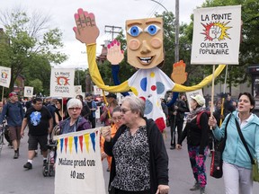 Community groups march in the Montreal district of Pointe-St-Charles on Thursday, June 13, 2019.