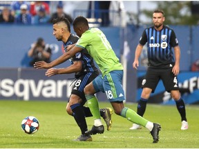 Impact midfielder Saphir Taider, left, and Sounders defender Kelvin Leerdam battle for the ball during first half at Saputo Stadium Wednesday night.