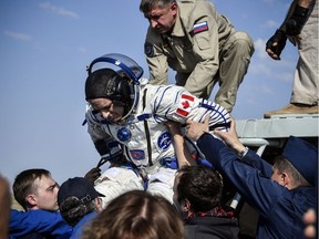 Ground personnel help David Saint-Jacques of the Canadian Space Agency to get out of the Soyuz MS-11 capsule shortly after landing in a remote area outside Zhezkazgan, Kazakhstan June 25, 2019. Alexander Nemenov/Pool via REUTERS