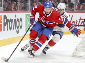 Montreal Canadiens' Charles Hudon holds off Florida Panthers' Aleksander Barkov during first period in Montreal on March 19, 2018.