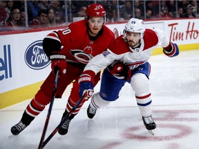 Canadiens centre Phillip Danault and Carolina Hurricanes centre Sebastian Aho battle for puck during NHL game at the Bell Centre in Montreal on Dec. 13, 2018.