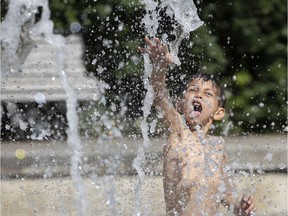 A child cools off in the fountains of Westmount Park in Montreal, on Wednesday, July 3, 2019.