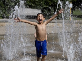 Omar El Kady cools off in the fountains of Westmount Park on Wednesday, July 3, 2019.