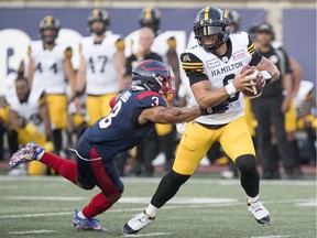 Hamilton Tiger-Cats quarterback Jeremiah Masoli avoids tackle by Montreal Alouettes Patrick Levels during Canadian Football League game in Montreal Thursday July 4, 2019.