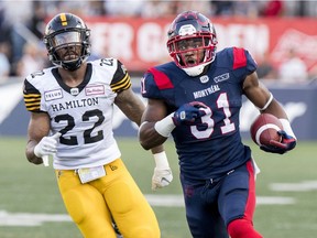 Montreal Alouettes William Stanback runs away from Hamilton Tiger-Cats Justin Tuggle for a long gain during Canadian Football League game in Montreal Thursday July 4, 2019.