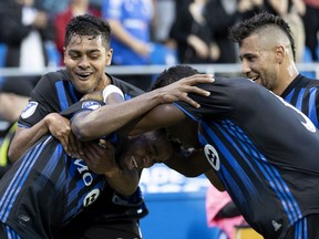 Montreal Impact forward Orji Okwonkwo, bottom left, celebrates with teammates after scoring against the Portland Timbers in Montreal on June 26, 2019.