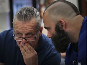 Antonio Zaruso (left), a General Vanier Elementary school governing board member and parent representative as well as a parent to a 3rd grade student and Giovanni Sardo, a parent of 2 Gerald McShane elementary school students speak during a special meeting called by the English Montreal School Board at its headquarters in Montreal Tuesday, July 9, 2019. The meeting was to discuss the Quebec Superior Court's decision to deny its request for an injunction to temporarily halt two school transfers ordered by Quebec Education Minister Jean-François Roberge.