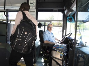 An STM driver for 41 years, Daniel Girard greets customers as he drives Route 36 in Montreal, on Wednesday, July 3, 2019.