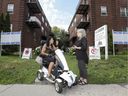 Felicia Tremblay de la Guardia, right, talks with neighbor Marie Pontini outside her Hampstead apartment buildings in Montreal.