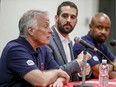 Montreal Alouettes president and CEO Patrick Boivin, centre, with assistant general manager of player personnel Joe Mack, left, and head coach Khari Jones at a press conference to answer questions about the firing earlier in the day of general manager Kavis Reed, in Montreal Sunday July 14, 2019.