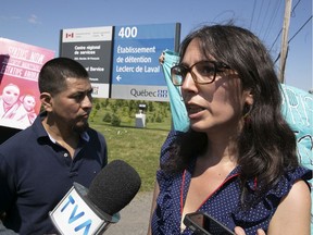 Protesters Amy Darwish, right, and Carmelo Monge outside the Laval Leclerc Institute on Monday July 15, 2019.