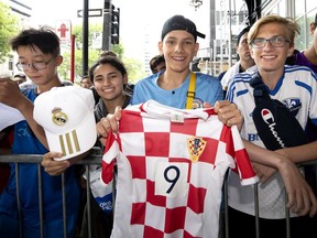 "They have world-class players — it’s hard to pick a favourite,” superfan Emily Bressi, second from left, says of Real Madrid. She and Yan Lin Win, left, Thomas Udovicich and Raphael Di Palo Parenteau were among those hoping to glimpse players outside the Ritz-Carlton in Montreal on Tuesday, July 16, 2019.