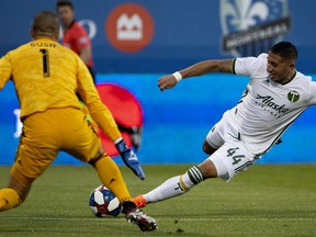 MONTREAL, QUE.: June 26, 2019 -- Montreal Impact goalkeeper Evan Bush (1) stops Portland Timbers midfielder Marvin Loria (44) during MLS action in Montreal, on Wednesday, June 26, 2019. (Allen McInnis / MONTREAL GAZETTE) ORG XMIT: 62764