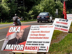 Protest signs on July 20 mark tensions in Kanesatake and Oka after Oka Mayor Pascal Quevillon's comments on an offer of land to the community of Kanesatake.