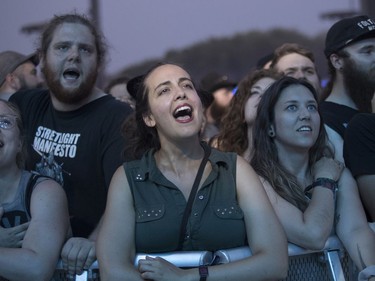 People sing along to a Streetlight Manifesto performance at the '77 Montréal punk festival at Parc Jean-Drapeau in Montreal on Friday, July 26, 2019.