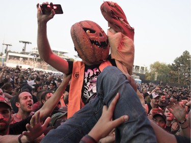 A crowd surfer comes over the top during the performance of Pennywise at the '77 Montréal punk festival at Parc Jean-Drapeau in Montreal on Friday, July 26, 2019.