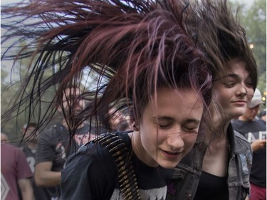 MONTREAL, QUE.: JULY 28, 2019 -- Young women whip their hair as Demolition Hammer played on day 2 of the Heavy Montréal metal festival on Sunday, July 28, 2019 at Parc Jean-Drapeau in Montreal. (John Kenney / MONTREAL GAZETTE) ORG XMIT: 62900