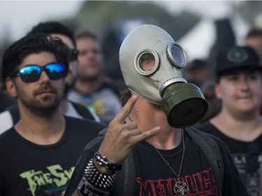 MONTREAL, QUE.: JULY 28, 2019 -- A man wears a gas mask while watching the band Clutch on day 2 of the Heavy Montréal metal festival on Sunday, July 28, 2019 at Parc Jean-Drapeau in Montreal. (John Kenney / MONTREAL GAZETTE) ORG XMIT: 62900