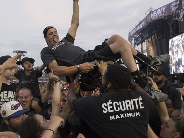 A man in a wheelchair crowd-surfs during the performance of Anthrax on day 2 of the Heavy Montréal metal festival.