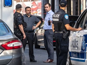 An 18-year-old man died of stab wounds, making him the ninth homicide victim of the year on the island of Montreal. Police officers confer at the command post July 29, 2019.