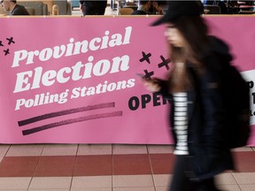 A student passes a pro-voting sign placed at the University of Alberta in Edmonton during the recent provincial election campaign.