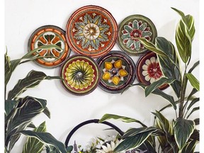 A decorative group of plates adds collected charm to the walls. Floral Plate Wall Collection, $150, Wayfair.ca