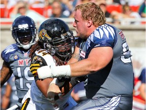 "First and foremost, I was blessed to get drafted by the Montreal Alouettes … that’s one thing that I was really happy about," says Montreal Alouettes' Luc Brodeur-Jourdain, battling Hamilton Tiger-Cats' Taylor Reed after losing his helmet in Montreal on Sept. 7, 2014.