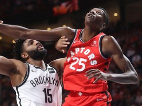 Raptors forward Chris Boucher, right, blocks Brooklyn Nets forward Alan Williams during NBA pre-season game in 2018. The Bell Centre crows gave Boucher, a Montreal native, a standing ovation when he entered the game.