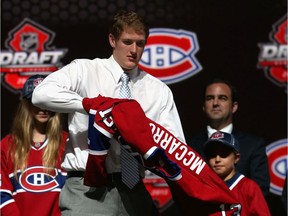 Mike McCarron puts on a Canadiens sweater after being selected by Montreal in the first round (25th overall) at the 2013 NHL Draft in New Jersey.