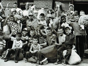 A group of boys, duffle bags packed, on July 9, 1951, prepare to leave from the Red Feather building on Atwater Ave. for two or three weeks at Camp Lewis in St-Adolphe-d'Howard. The uncropped photo is embedded in the text.