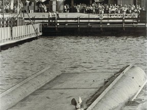July 8, 1979. Late in the afternoon a sightseeing boat capsized on an artificial lake at the La Ronde amusement park at Man and His World. Three people drowned and about 10 were taken to hospital. The boat is seen here lying upside down in the lake. Handwritten on the back of the photograph is this chilling observation: "Activity continues at La Ronde as boat sinks in foreground."