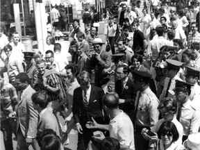 Fair-goers at Montreal's Expo 67 greet U.S. Senator Robert F. Kennedy (in dark suit and striped tie at bottom centre of photo) on July 6, 1967.