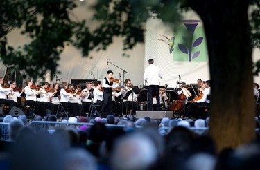 MONTREAL, QUE.: July 23, 2019 -- Guest violinist Kerson Leongas joins the OSM as they perform in Wilfrid-Bastien Park as part of the Consil des arts de Montreal OSM in the Parks series, in Montreal, on Tuesday, July 23, 2019. (Allen McInnis / MONTREAL GAZETTE) ORG XMIT: 62893