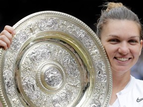 Romania's Simona Halep poses with the Venus Rosewater Dish trophy after beating U.S. player Serena Williams during their women's singles final on Day 12 of the 2019 Wimbledon Championships at The All England Lawn Tennis Club in Wimbledon, southwest London, on Saturday, July 13, 2019.