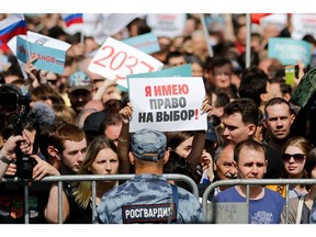 Demonstrators take part in a rally to support opposition and independent candidates after authorities refused to register them for September elections to the Moscow City Duma, Moscow, July 20, 2019.