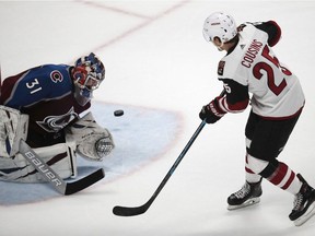 Colorado Avalanche goaltender Philipp Grubauer, left, stops a shot by Arizona Coyotes centre Nick Cousins during a shootout on March 29, 2019, in Denver.