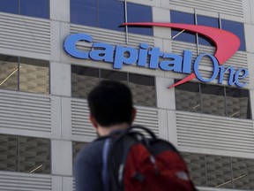 A man walks across the street from a Capital One location in San Francisco on July 16, 2019. A hacker gained access to personal information from more than 100 million Capital One credit applications, including six million from Canada, the bank said Monday as federal authorities arrested a suspect in the case.