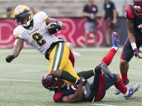CP-Web. Montreal Alouettes Patrick Levels, bottom, tackles Edmonton Eskimos' C.J. Gable during first half CFL football action in Montreal, Saturday, July 20, 2019.