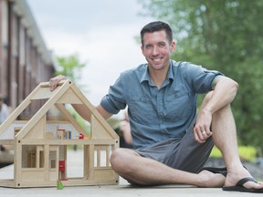 Sustainable Living Expert Kenton Zerbin poses next to a playhouse in Montreal, Sunday, June 30, 2019, during a break from a workshop on building Tiny Homes.