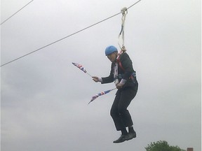This mobile phone photo provided by Lee Medcalf shows Boris Johnson, the mayor of London, dangling in midair above the crowds at an open-air viewing site at east London's Victoria Park, on Wednesday, Aug. 1, 2012.