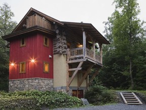 The eclectic mix of materials gives the illusion that the Scandinavian log portion of the home is sitting on top of another house.