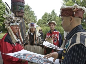 Andrew Tanahokate Delisle receives a painting from Kevin Cranmer in 2007, after a ceremony marking the 40th anniversary of Expo 67. When escorting Queen Elizabeth II at Expo 67, Delisle didn't shy away from telling her harsh truths about the mistreatment of First Nations people.