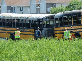 The aftermath is seen following a collision between two school buses on Autoroute 640 near Saint-Eustache, Que. on Tuesday, July 23, 2019.