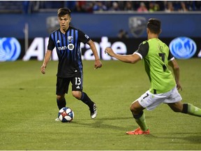 Montreal Impact midfielder Ken Krolicki (13) dribbles the ball as York9 FC forward Austin Ricci (7) defends at Saputo Stadium.