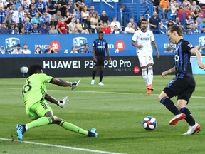 Montreal Impact midfield Lassi Lappalainen (21) plays the ball in front of Philadelphia Union goalkeeper Andre Blake (18) during the first half at Saputo Stadium.