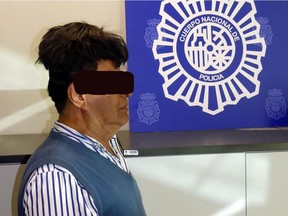 A man poses with a toupee with a drug package under it after being arrested in Barcelona, Spain, in this picture released on July 16, 2019. Spanish National Police via REUTERS ATTENTION EDITORS - THIS IMAGE HAS BEEN SUPPLIED BY A THIRD PARTY. NO RESALES. NO ARCHIVE. FACE OBSCURED AT SOURCE