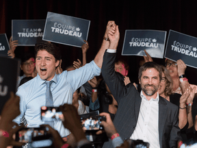 Prime Minister Justin Trudeau raises the hand of Steven Guilbeault during an event to launch his candidacy for the Liberal party of Canada in Montreal, July 10, 2019.